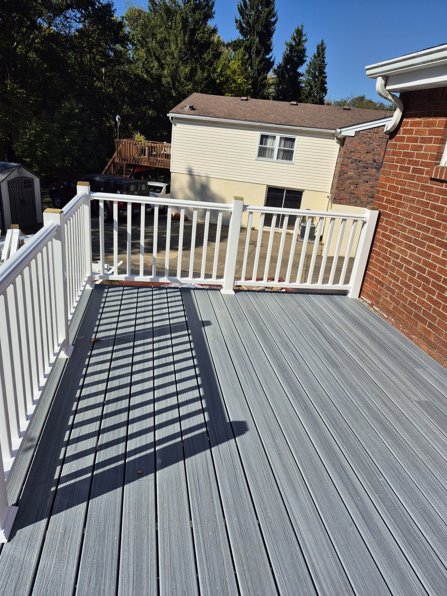 Finished composite deck with white railings and balusters