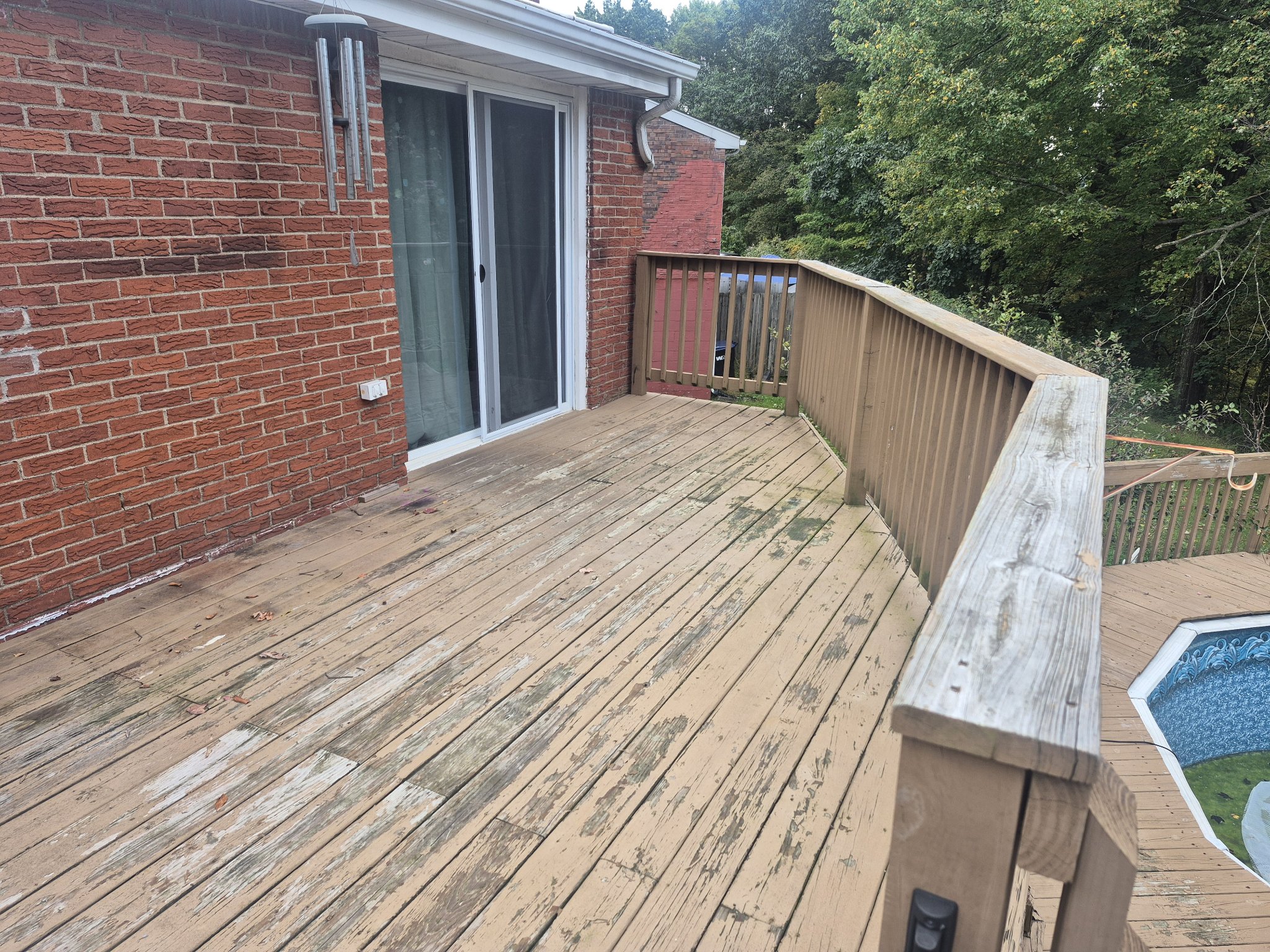 Aged wooden deck railings before replacement
