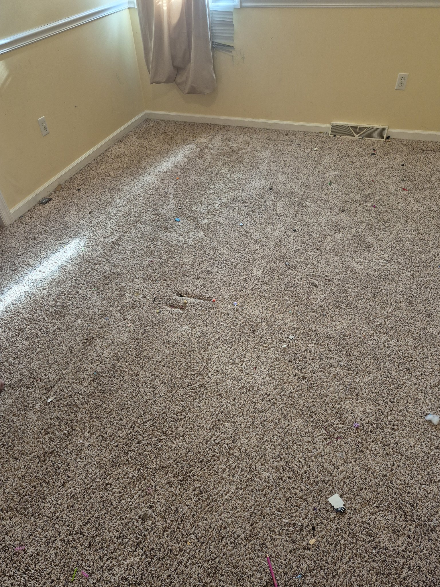 Old worn carpet in bedroom before flooring replacement