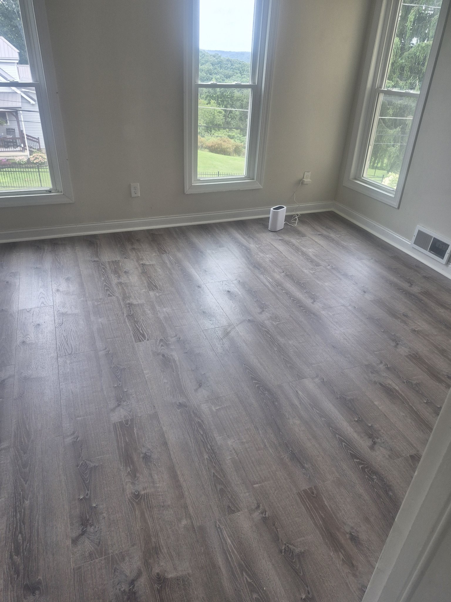 Finished luxury vinyl plank flooring in bright room