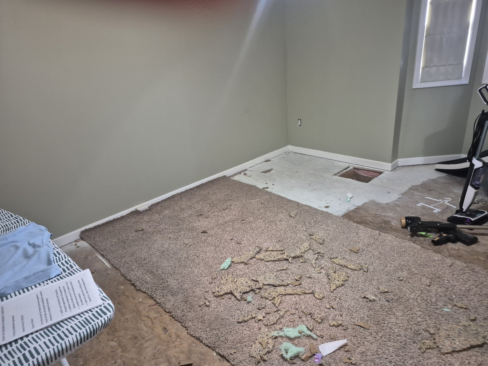 Carpet torn out exposing subfloor during flooring replacement